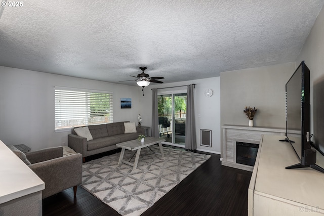 7364 SW 175th Ter, Beaverton, OR 97007 - living area featuring a premium fireplace, wood finished floors, a ceiling fan, a textured ceiling, and baseboards