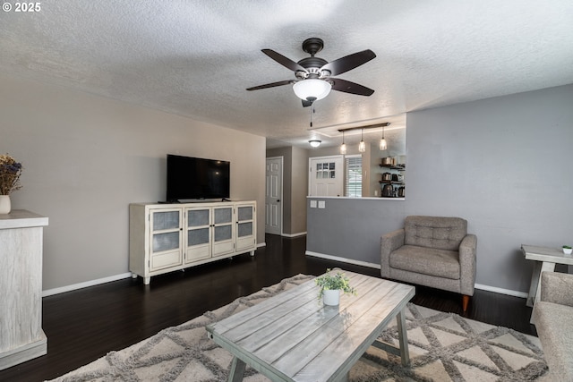 7364 SW 175th Ter, Beaverton, OR 97007 - living room with a textured ceiling, ceiling fan, baseboards, and dark wood-style flooring