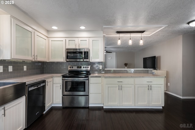 7364 SW 175th Ter, Beaverton, OR 97007 - kitchen featuring stainless steel appliances, a peninsula, white cabinetry, light countertops, and a textured ceiling