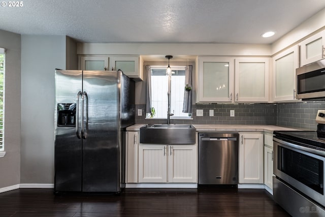 7364 SW 175th Ter, Beaverton, OR 97007 - kitchen with stainless steel appliances, light countertops, healthy amount of natural light, and a sink