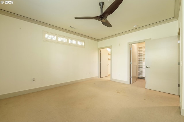 1951 NW Hoyt St, Portland, OR 97209 - unfurnished bedroom featuring light colored carpet, a walk in closet, baseboards, ceiling fan, and a closet