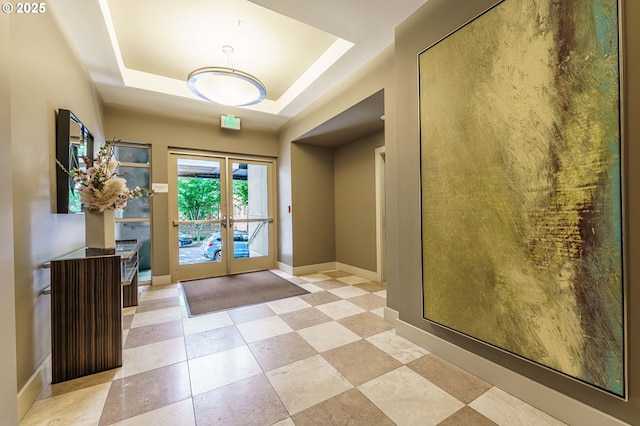 1951 NW Hoyt St, Portland, OR 97209 - foyer featuring french doors, a raised ceiling, and baseboards