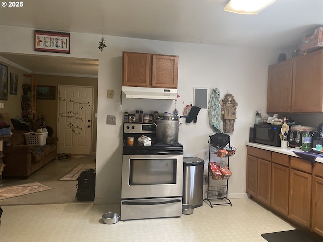 629 NE Johnson St, Myrtle Creek, OR 97457 - kitchen with under cabinet range hood, stainless steel range with electric stovetop, black microwave, and brown cabinets