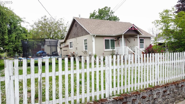 629 NE Johnson St, Myrtle Creek, OR 97457 - bungalow-style home featuring roof with shingles and a trampoline