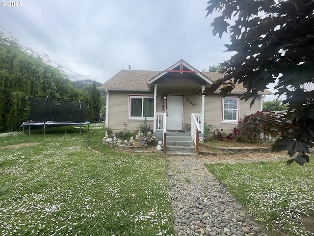 629 NE Johnson St, Myrtle Creek, OR 97457 - bungalow-style home with a trampoline, a front yard, and roof with shingles