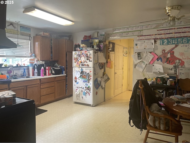 629 NE Johnson St, Myrtle Creek, OR 97457 - kitchen with freestanding refrigerator, ceiling fan, brown cabinetry, and light floors