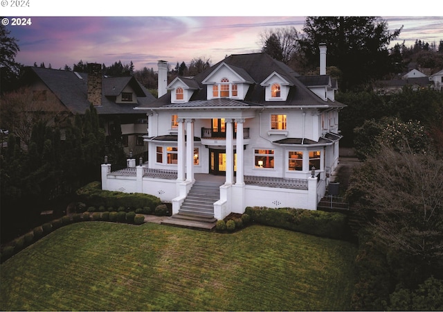 greek revival house featuring a yard and a balcony