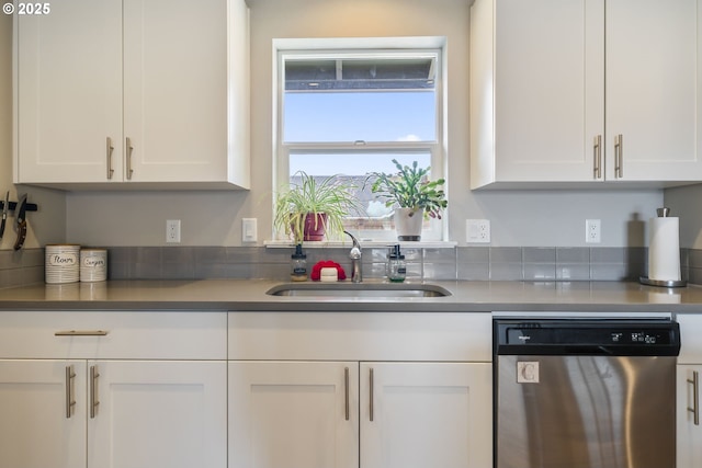 kitchen featuring a sink, dishwasher, and white cabinets