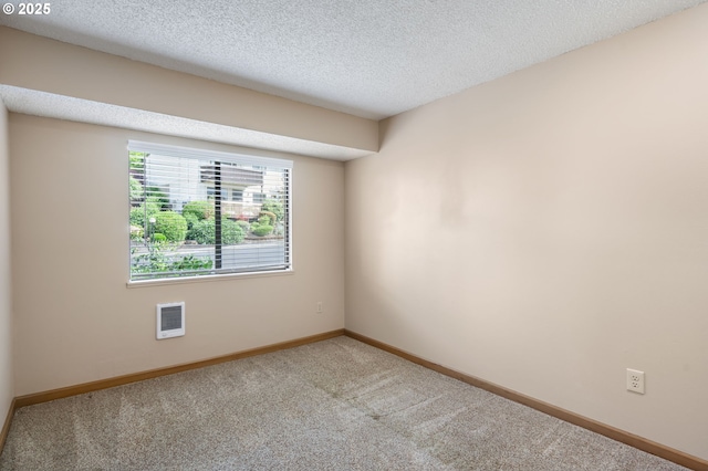 12110 SW King Arthur St, Portland, OR 97224 - empty room with carpet flooring, heating unit, and a textured ceiling