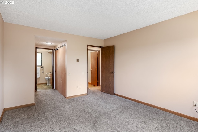 12110 SW King Arthur St, Portland, OR 97224 - unfurnished bedroom with carpet flooring, a textured ceiling, connected bathroom, and a closet