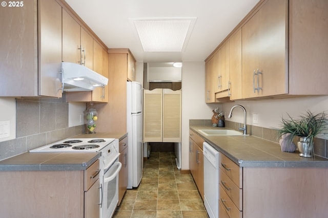 12110 SW King Arthur St, Portland, OR 97224 - kitchen with white appliances, under cabinet range hood, backsplash, stone finish floors, and dark countertops