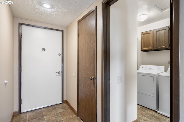 12110 SW King Arthur St, Portland, OR 97224 - washroom featuring washing machine and dryer, cabinet space, and a textured ceiling