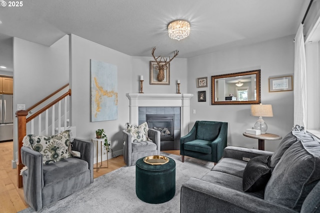 2733 NE 77th Pl, Portland, OR 97213 - living room featuring light wood-type flooring, a tile fireplace, and stairway
