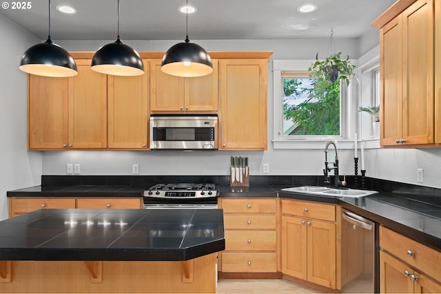 2733 NE 77th Pl, Portland, OR 97213 - kitchen featuring appliances with stainless steel finishes, pendant lighting, a breakfast bar, recessed lighting, and light brown cabinets