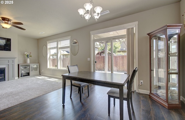 9817 NE 106th St, Vancouver, WA 98662 - dining room with a chandelier, dark wood-type flooring, ceiling fan, and a glass covered fireplace