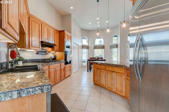 kitchen with sink, light tile patterned floors, hanging light fixtures, a center island, and black appliances