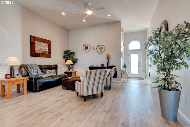 living room featuring ceiling fan and light wood-type flooring