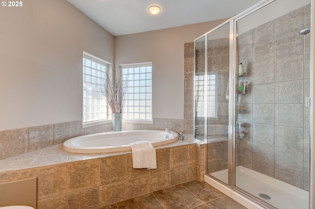 bathroom with tile patterned floors and separate shower and tub