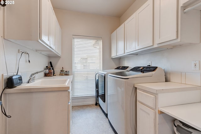 laundry area with cabinets, sink, and washer and dryer