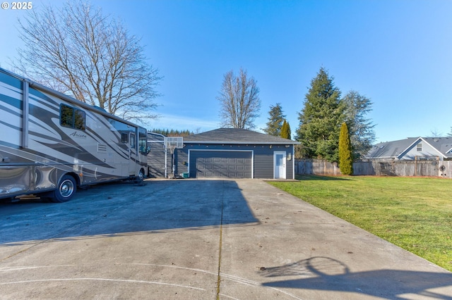 view of side of property featuring a garage and a yard