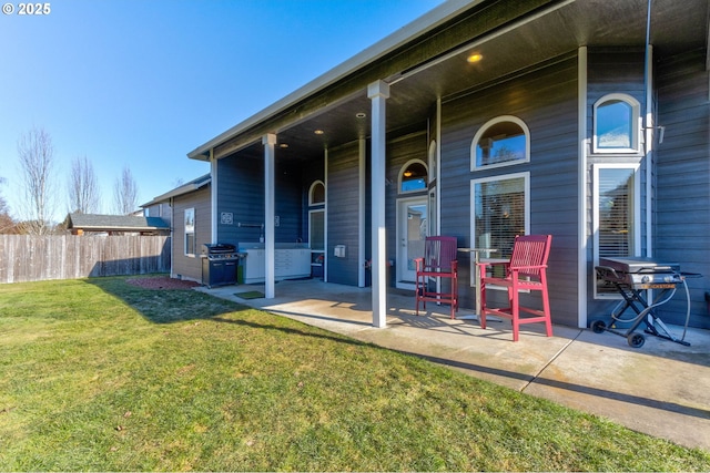 back of house with a yard and a patio