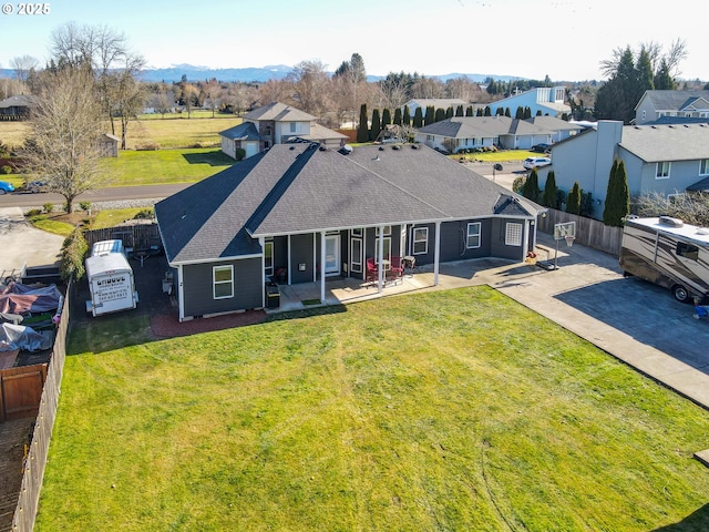 back of property featuring a patio area and a lawn