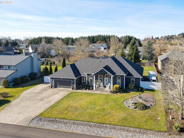 single story home featuring a garage and a front lawn