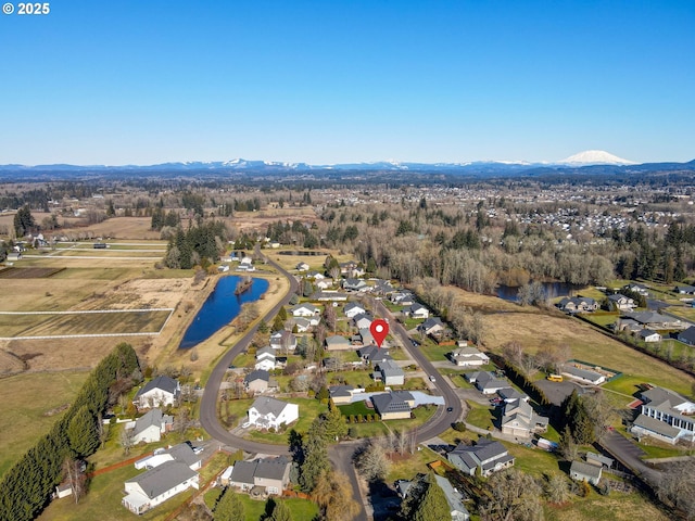 drone / aerial view with a water and mountain view