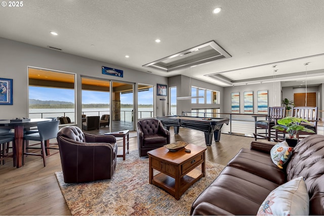 794 S A St, Washougal, WA 98671 - living room with a textured ceiling, wood finished floors, a tray ceiling, a water view, and billiards table