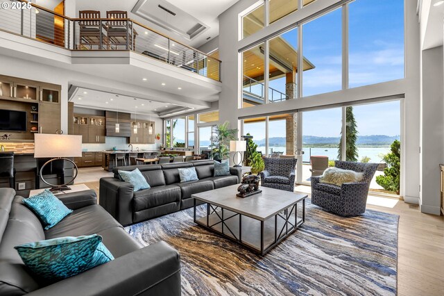 794 S A St, Washougal, WA 98671 - living area featuring a towering ceiling, a water view, light wood-style floors, and recessed lighting