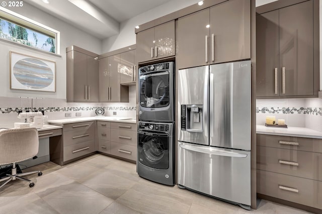 794 S A St, Washougal, WA 98671 - kitchen featuring stainless steel refrigerator with ice dispenser, gray cabinetry, stacked washer / drying machine, modern cabinets, and tasteful backsplash