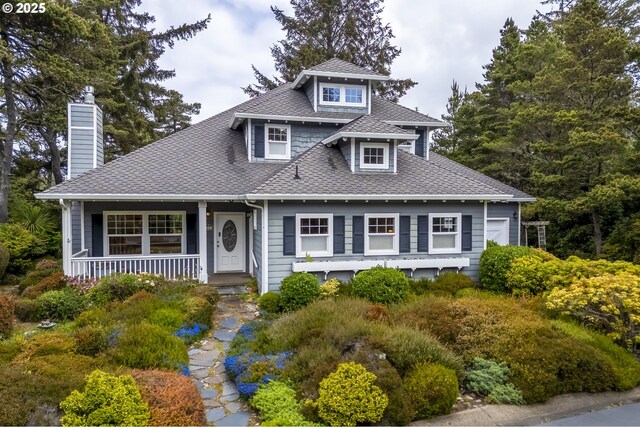 110 SW 61st St, South Beach, OR 97366 - view of front of property featuring roof with shingles, a porch, and a chimney