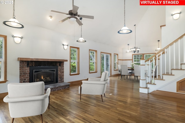 110 SW 61st St, South Beach, OR 97366 - living area with healthy amount of natural light, wood finished floors, a ceiling fan, a fireplace, and high vaulted ceiling