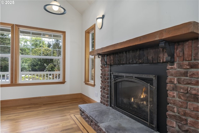 110 SW 61st St, South Beach, OR 97366 - detailed view of wood finished floors, a fireplace, and baseboards