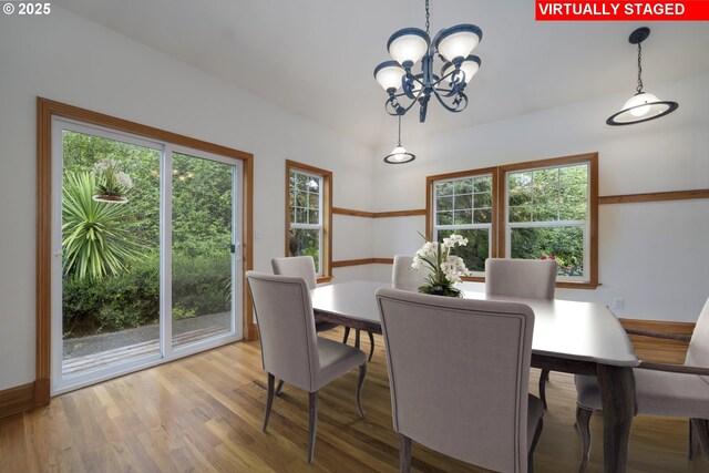 110 SW 61st St, South Beach, OR 97366 - dining area with a chandelier, wood finished floors, and vaulted ceiling
