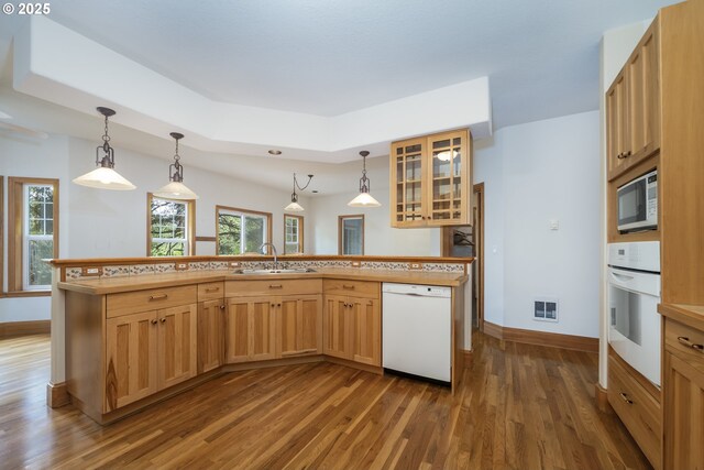 110 SW 61st St, South Beach, OR 97366 - kitchen featuring white appliances, a sink, dark wood finished floors, baseboards, and glass insert cabinets