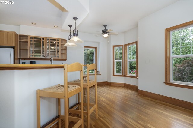 110 SW 61st St, South Beach, OR 97366 - kitchen featuring wood finished floors, ceiling fan, freestanding refrigerator, baseboards, and open shelves