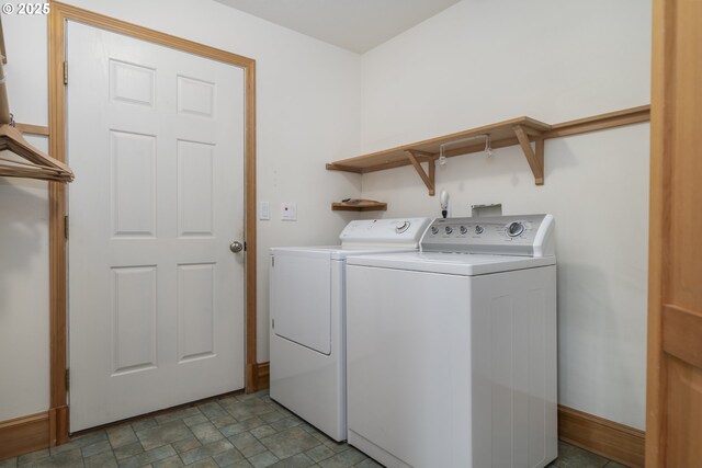 110 SW 61st St, South Beach, OR 97366 - washroom featuring separate washer and dryer, stone finish floors, and baseboards