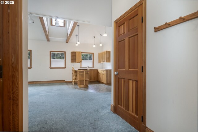 110 SW 61st St, South Beach, OR 97366 - kitchen featuring beam ceiling, dark colored carpet, light countertops, baseboards, and a skylight