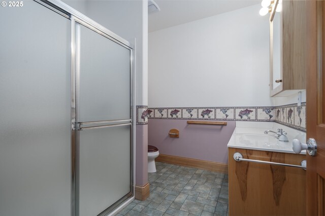 110 SW 61st St, South Beach, OR 97366 - bathroom featuring vanity, a shower stall, toilet, and stone finish floors