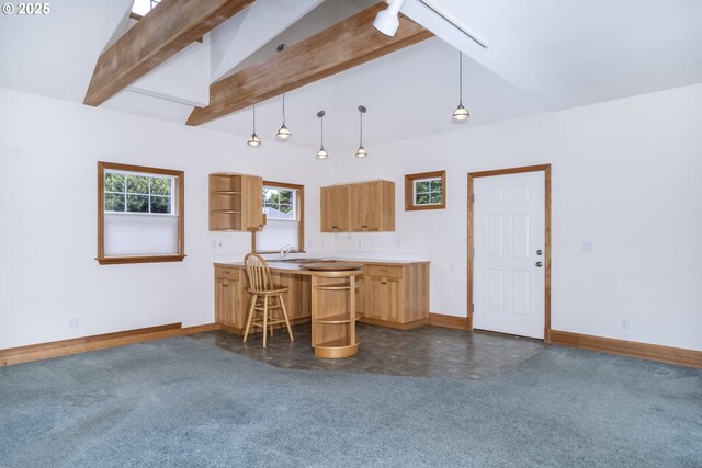 110 SW 61st St, South Beach, OR 97366 - kitchen with dark carpet, baseboards, a kitchen bar, and light countertops