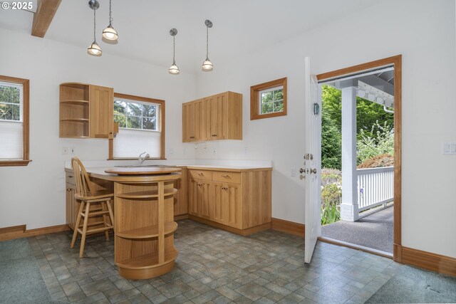 110 SW 61st St, South Beach, OR 97366 - kitchen featuring open shelves, stone finish floors, baseboards, and light countertops