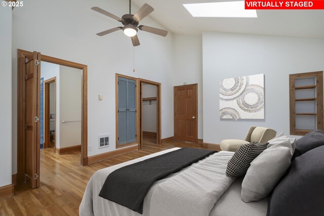 110 SW 61st St, South Beach, OR 97366 - bedroom featuring a skylight, high vaulted ceiling, baseboards, wood finished floors, and heating unit