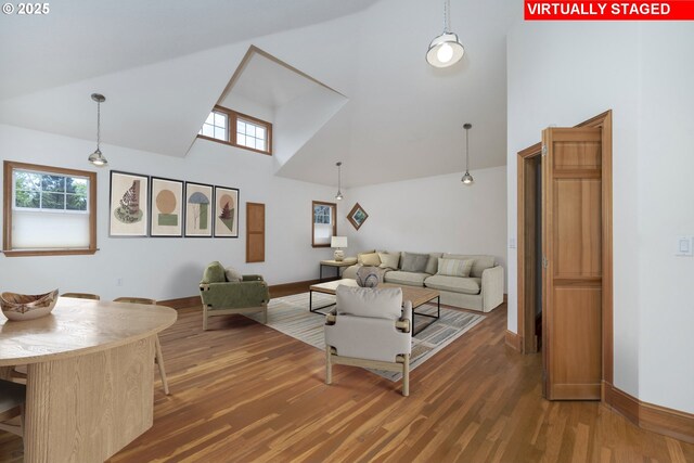 110 SW 61st St, South Beach, OR 97366 - living area with high vaulted ceiling, plenty of natural light, wood finished floors, and baseboards