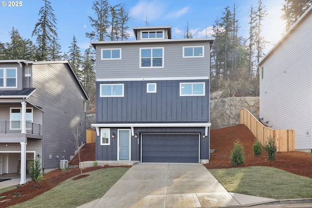 view of front of house featuring a garage, cooling unit, and a front lawn