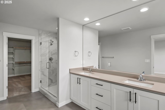 bathroom with vanity and a shower with shower door