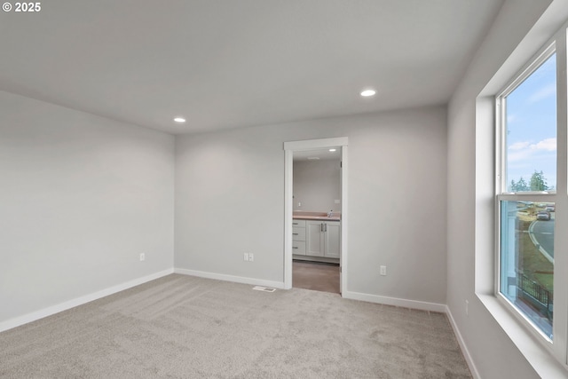 unfurnished room featuring carpet