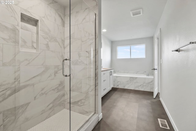 bathroom with vanity and independent shower and bath