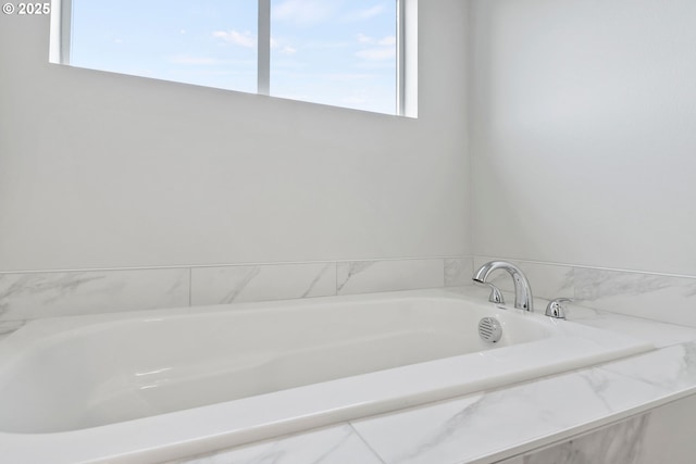 bathroom featuring tiled bath