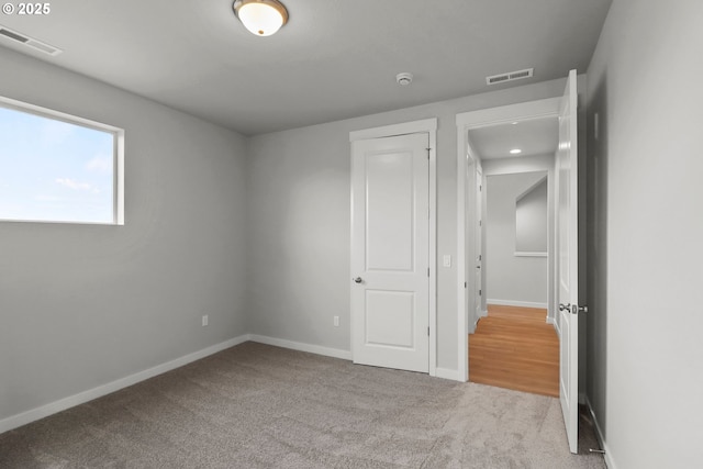 unfurnished bedroom with light colored carpet